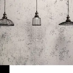 Trzy lampy wiszące w industrialnym stylu na tle ściany pokrytej betonową farbą. Ta farba nadaje wnętrzu surowy, loftowy charakter.